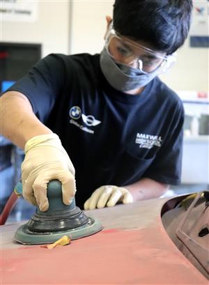 student sanding car